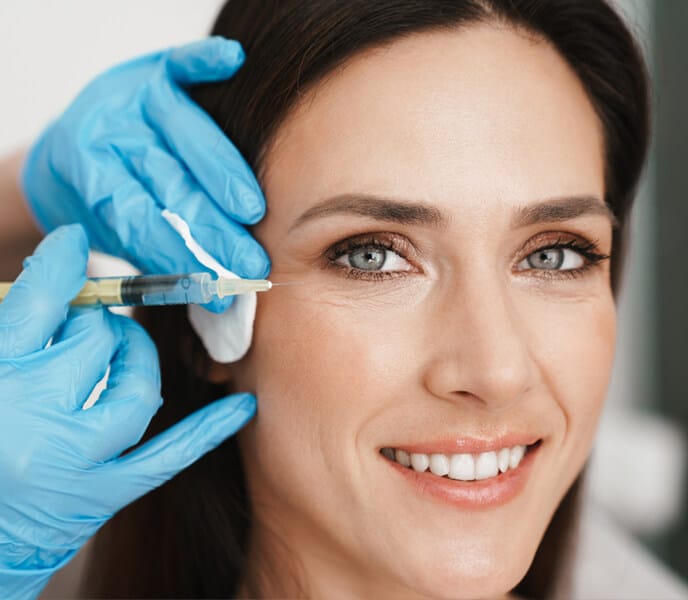 a close up of a woman who is smiling and looking at the camera